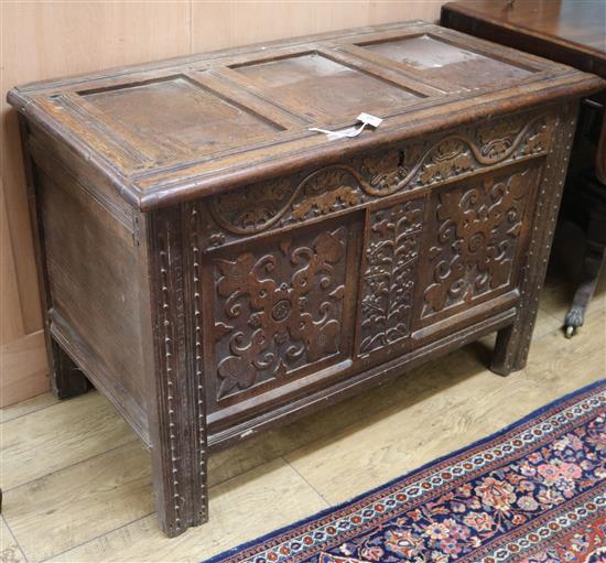 A carved oak coffer W.101cm